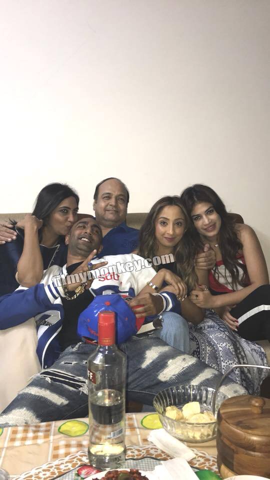 Arshi kissing Akash as they pose along with Bandgi and his family on his welcome home party post eviction.