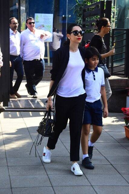 Karisma-Kiaan head for the car as ex-hubby Sanjay awaits them to drive off