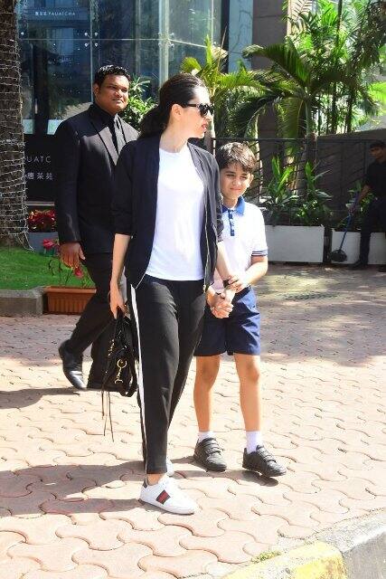 Karisma-Kiaan head for the car as ex-hubby Sanjay awaits them to drive off