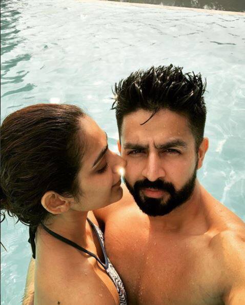 Here's another picture in which Aakanksha gets romantic with hubby. The picture has been captioned as,
