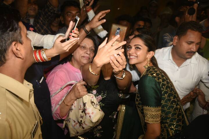Deepika posing for selfies with fans