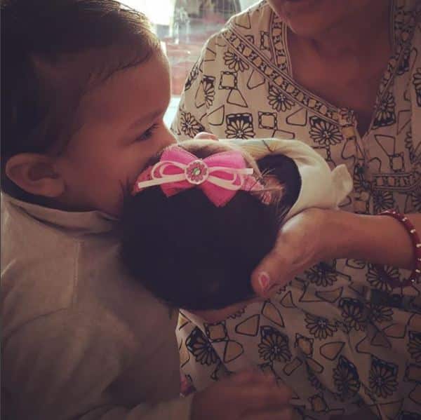 Few days back she had shared this pic of her elder daughter kissing the younger one!