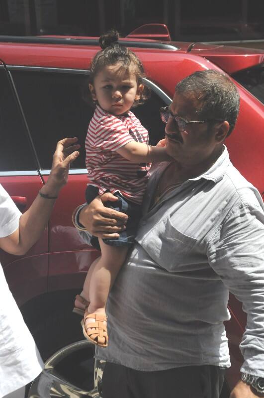 And then the nanny takes him in her arms while the little nawab was busy gazing at the cameras that were stuck on him