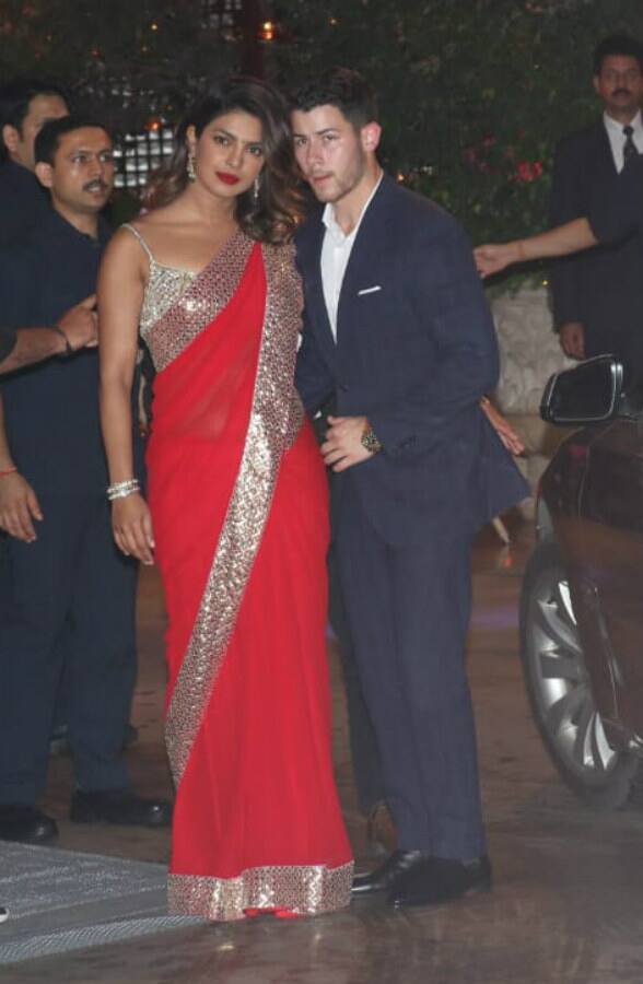 Priyanka Chopra looks stunning in a red-saree as she arrives with rumored beau Nick. (Photo: Manav Manglani)