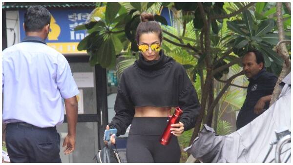 Malaika was seen in a black gym outfit that included leggins and a crop-top.