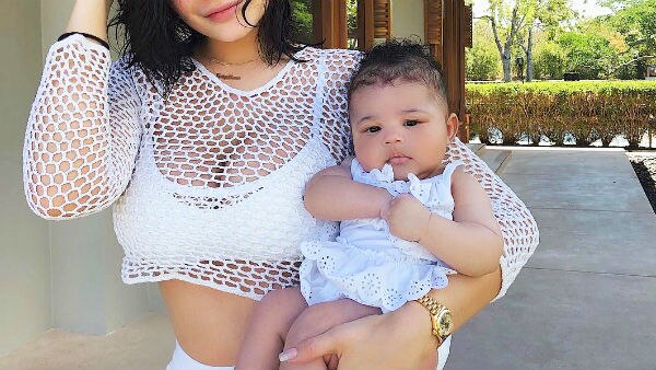 Kylie Jenner Wears Minidress, White Sandals in France With Baby Stormi –  Footwear News