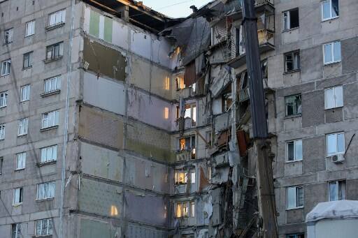  The blast destroyed 35 apartments and damaged 10 more, leaving dozens of people homeless over the New Year -- the biggest holiday of the year in Russia. (Photo by STR / AFP)