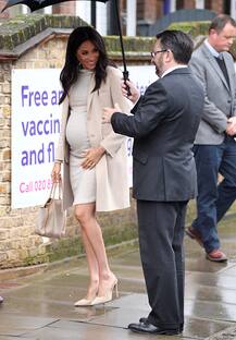IN PICTURES: Pregnant Meghan Markle flaunts baby bump as she steps out in $35 dress
