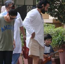 Taimur Ali Khan\'s little guitarist avatar is too Awww; Spotted on evening stroll with mom-dad Kareena and Saif!