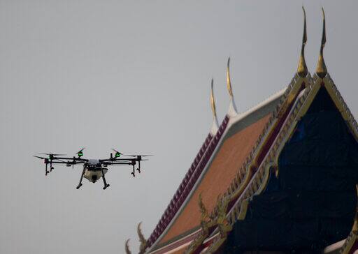 the crisis-level pollution, along with public awareness, has been spurred by meteorological events that trap the noxious pollution. These include a thermal inversion, which keeps the dangerous particles closer to the ground, and weak winds which fail to blow them away. Drone pilots fly a water-spraying drone over the Suthat Temple . (AP Photo/Sakchai Lalit)