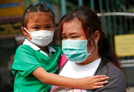 Prime Minister Prayuth Chan-ocha ordered inspections of factories to measure the pollution they are emitting. But he warned that implementing radical solutions could cause inconveniences that people might be unwilling to accept. A parent and child wear protective masks for the high levels of air pollution (AP Photo/Sakchai Lalit)