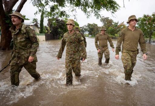 Australia's military has been deployed to tackle the devastating floods that have inundated homes, schools and airports in the country's northeast, forcing hundreds to flee and bringing crocodiles onto the streets. (Photo by PTE Brodie Cross / AUSTRALIA DEPARTMENT OF DEFENCE / AFP) 
