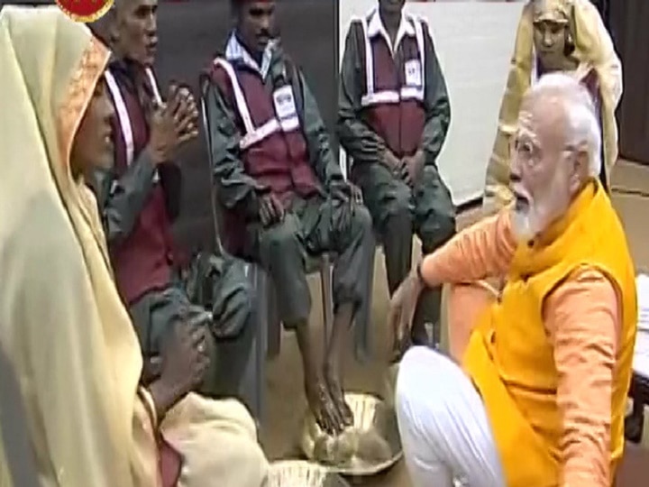 PM Modi washes feet of sanitation workers at Kumbh in Prayagraj PM Modi visits Kumbh, offers prayers, washes feet of sanitation workers