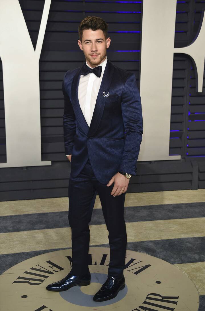 Nick too looked dapper in a navy suit and a black bow tie.(Photo by Evan Agostini/Invision/AP)
