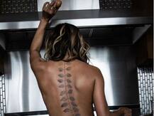 Oscar-winning actress Halle Berry poses topless to show off her latest tattoo!