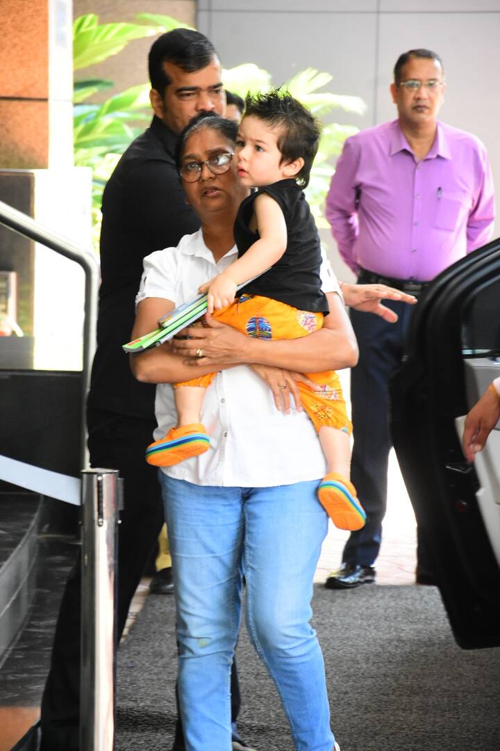 Meanwhile, Baby Taimur donning a black tee with cute yellow pants flaunted his new hairstyle nestled in his nanny’s arms. 
