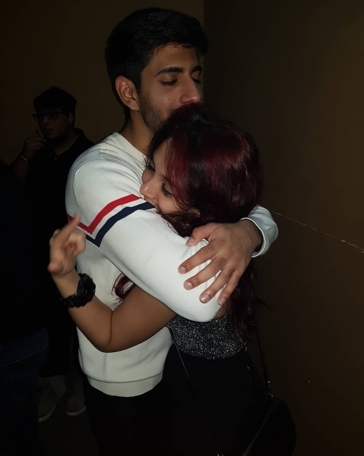 Ira and Mishaal share a tight hug.