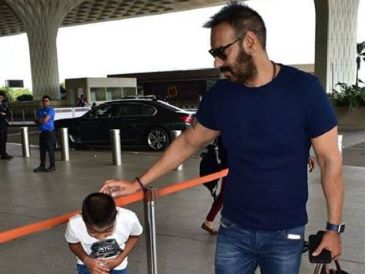 Watch Ajay Devgn son Yug Devgn at Mumbai airport as the father-son duo head to Singapore!  Watch: Ajay Devgn's little son Yug gets irritated by Paparazzi lights at Mumbai airport; SEE PICS & VIDEO