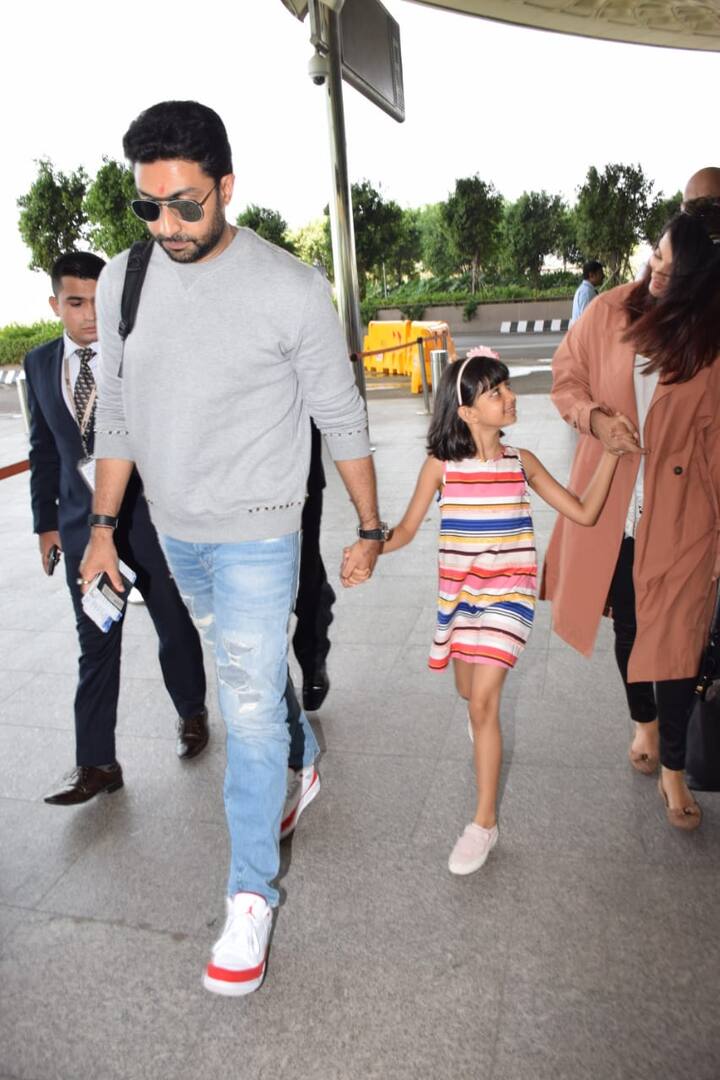 Lil Aaradhya looked cute in her short multi-coloured frock and pink shoes. She was also sporting her favourite pink hairband 