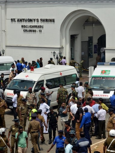 Ambulances are seen outside the church premises with gathered people and security personnel following a blast at the St. Anthony's Shrine in Kochchikade, Colombo on April 21, 2019.(Photo by ISHARA S. KODIKARA / AFP)