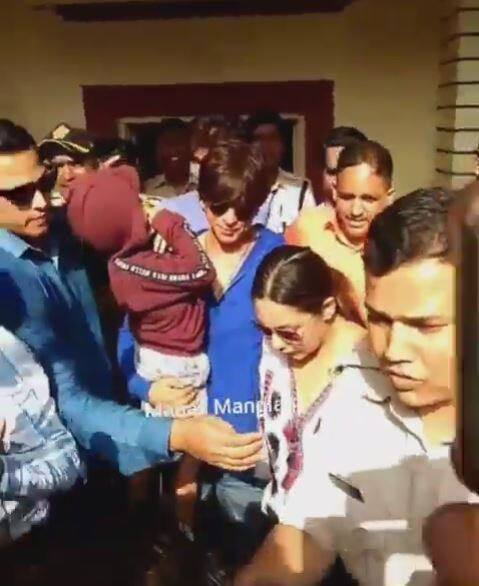 SRK with Abram in his arms, leaving the booth post casting vote with wife Gauri