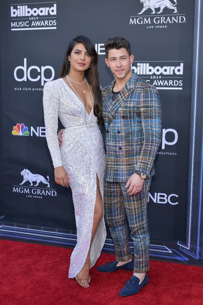 Nick went for vintage vibes in a plaid suit worn with tasseled blue suede loafers