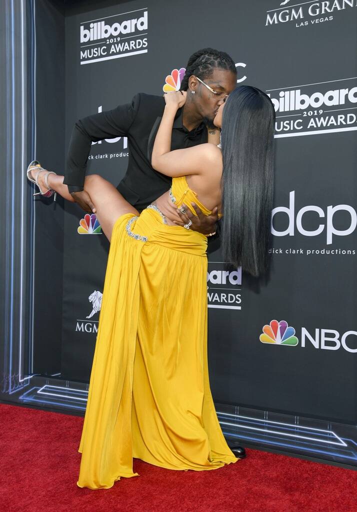 The two were photographed french kissing on the carpet