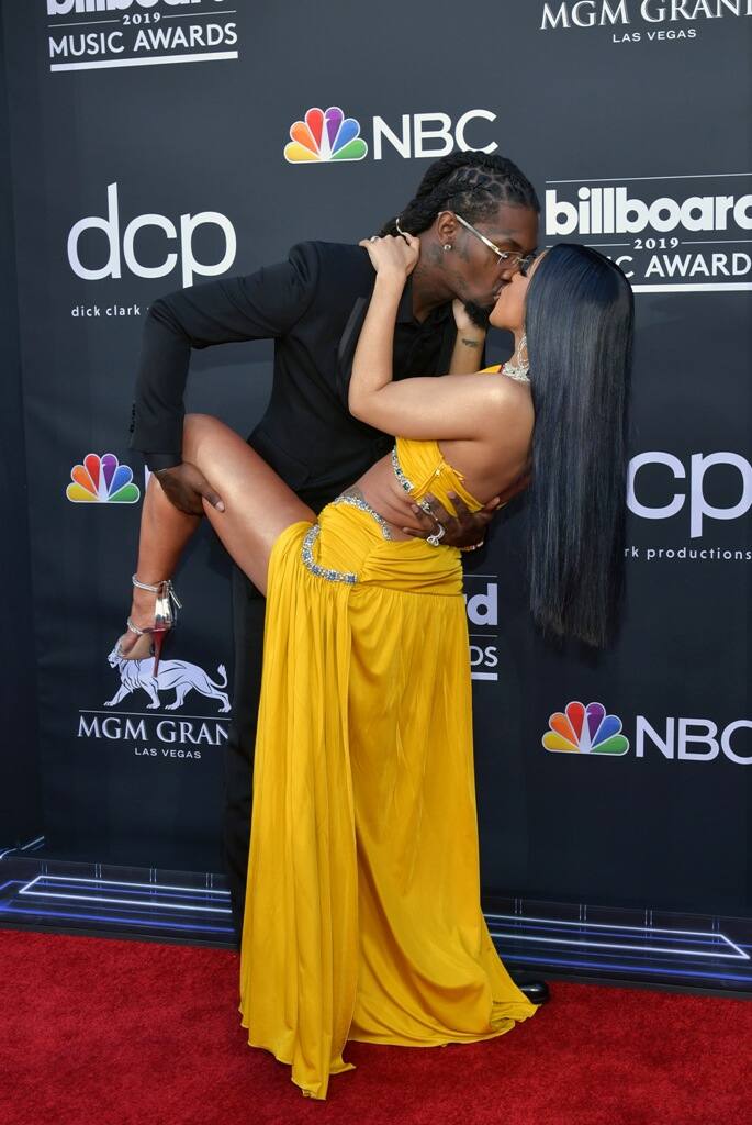 The pair stopped at the red carpet to pose for photos and ramped up the PDA with French kisses.