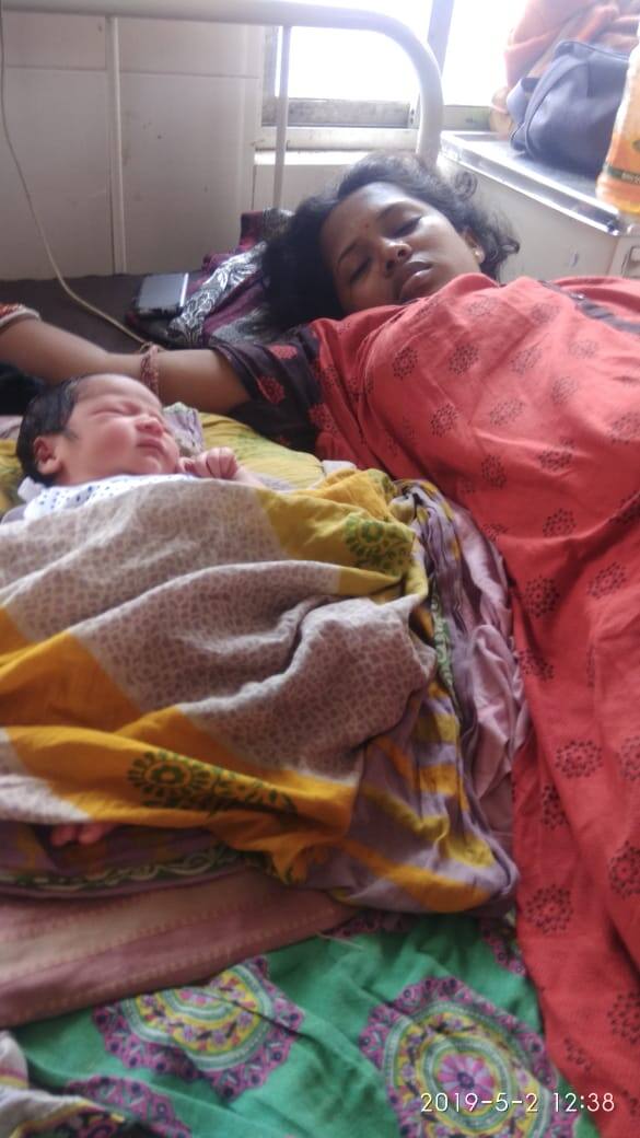 A woman and her new born child take rest at a hospital Bhadrak, Odisha.