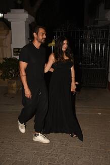 IN PICS: Arjun Rampal\'s pregnant girlfriend Gabriella flaunts her BABY BUMP as the couple TWIN in Black at a party!