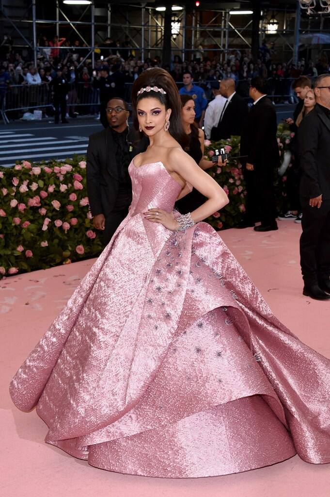 Keeping up with this year's theme 'Camp: Notes on Fashion', Deepika Padukone stepped out in an exaggerated version of Barbie with a pink Zac Posen gown at Met Gala 2019[Pic credit: Getty] 