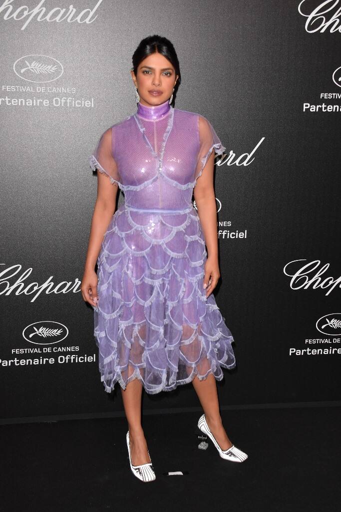 Her look was accessorised with statement diamond earrings and a pair of quirky acrylic heeled pumps.
