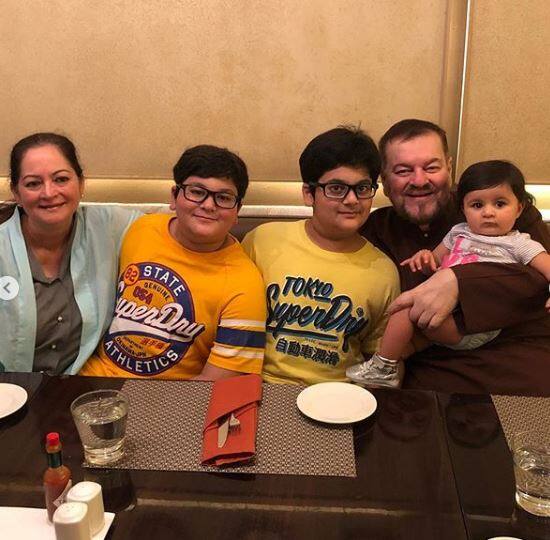 Here's the lil one comfortably sitting on her grandfather Nitin Mukesh's lap 