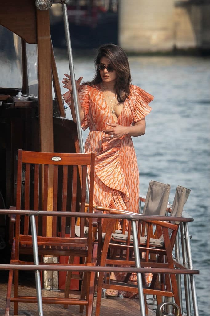 Oozing glamour on the outing, Priyanka donned a plunging gown with a thigh high split that offered a look at her cleavage and lean legs.