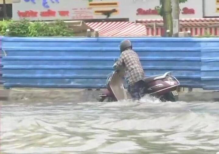 Streets in the city flooded due to heavy rainfall, people wade through water in Gandhi Market area