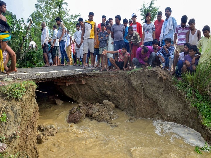 Muzaffarpur: Villagers sit beside a patch of eroded land, following heavy monsoon rain in Muzaffarpur, Monday, July 15, 2019. (PTI Photo)(PTI7_15_2019_000162B)