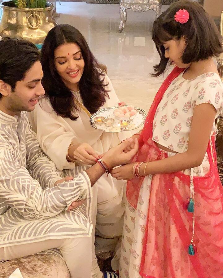 Aaradhya looking pretty in a white lehenga with red chunni, tying rakhi to Agastya Nanda who looked handsome in a cream pyjama-kurta
