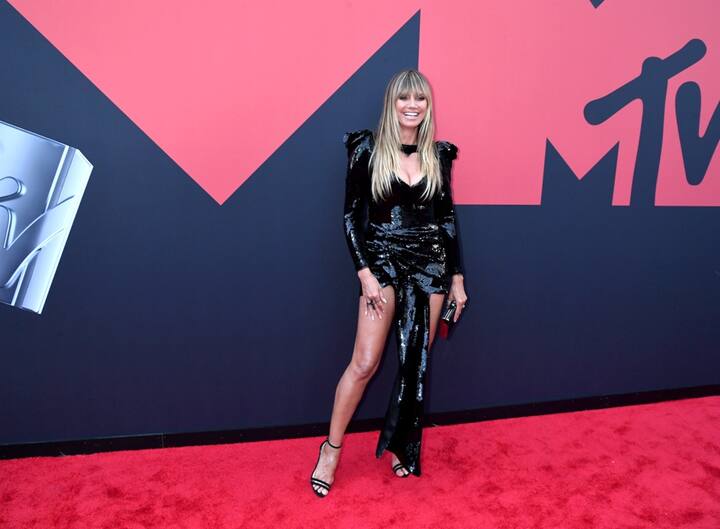 Heidi Klum put on a busty display in a low-cut, shimmering black mini dress[pic credit: Gettyimages] 