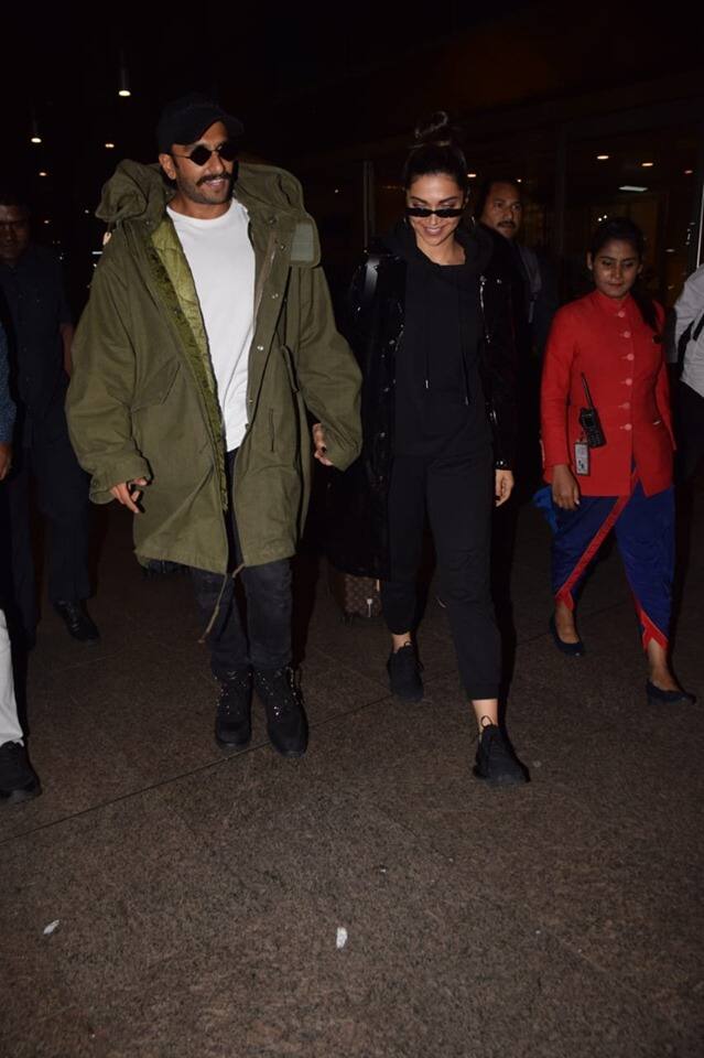 Ranveer Singh spotted a hefty olive green overcoat while his wife Deepika wore an all-black outfit. 