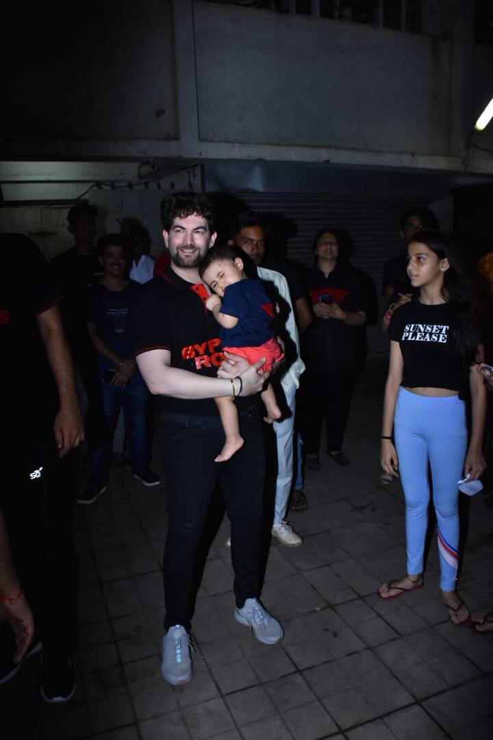 The adorable baby girl was clung to her daddy's arms