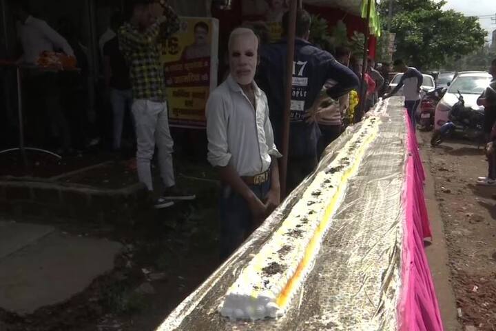 BJP workers in Bhopal cut a 69 feet long cake yesterday, ahead of Prime Minister Narendra Modi's birthday (Courtesy: ANI)