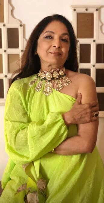 She accessorized her outfit with a big chunky neck-piece and a ring
