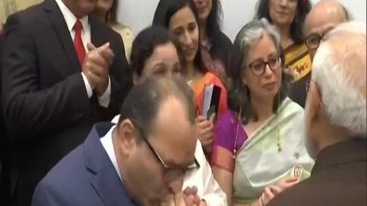 One member of the delegation kissed PM Modi's hands and said, 