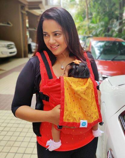The actress can be cuddling her lil girl in a baby carrier 