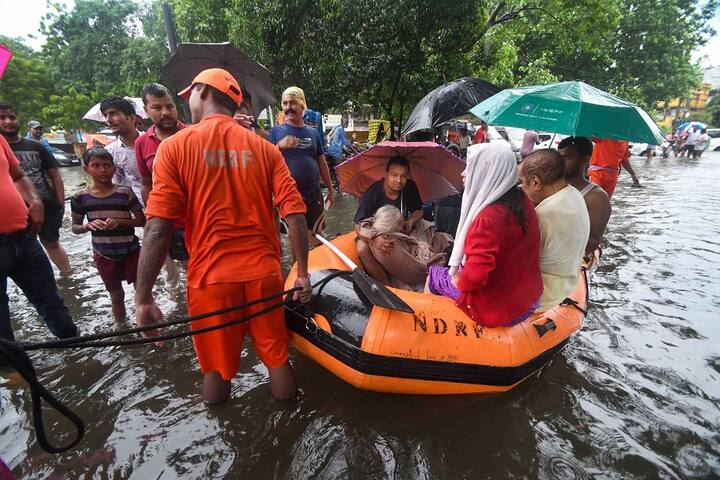 NDRF workers rescue an elderly patient from flood-affected area of Bahadurpur following heavy monsoon rainfall, in Patna. (PTI Photo)