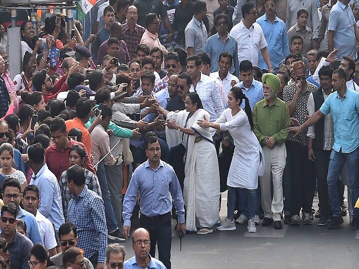 West Bengal Chief Minister Mamata Banerjee greets people with TMC MP Mimi Chakraborty as they lead a rally, vowing not to allow the proposed countrywide NRC and the Amended Citizenship Act in West Bengal in Kolkata. (Image: PTI)