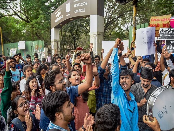 Students hold placards as they raise slogans during a protest against Citizenship Amendment Act (CAA) and National Register of Citizens (NRC) at Fergusson College, in Pune. (Image: PTI)