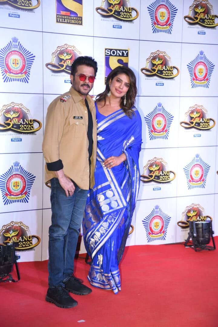 International icon Priyanka Chopra looked beautiful in a blue saree. Here's a picture of PeeCee posign with Anil Kapoor at 'Umang 2020' red carpet. (Photo: Manav Manglani)