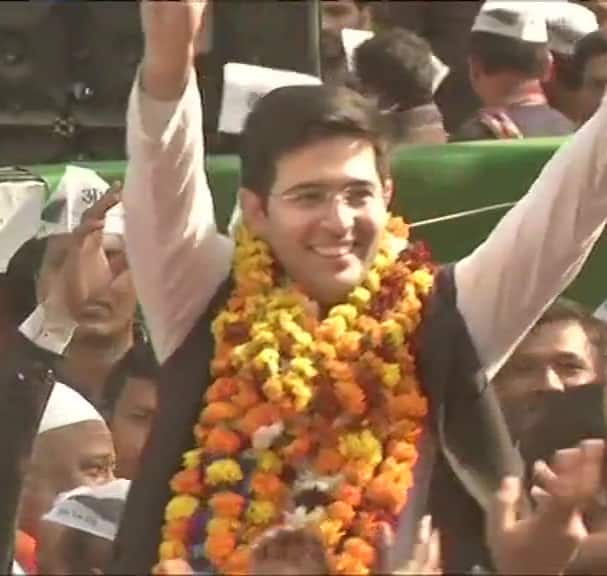 AAP's candidate from Rajinder Nagar constituency Raghav Chadha celebrates with party workers as trends show he is leading. (Photo Credit: ANI)