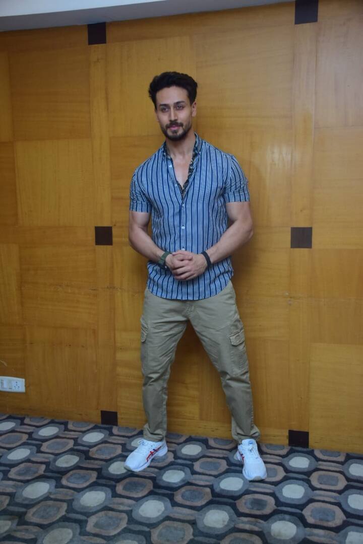 Tiger Shroff looked handsome in a blue striped shirt and beige pants. 